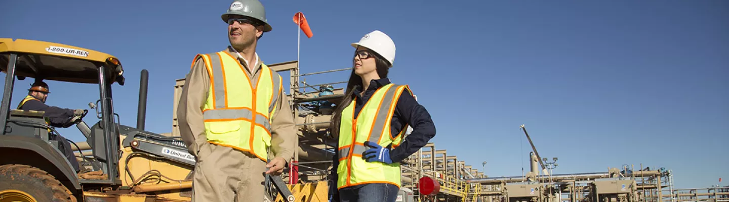 man and woman on construction site in PPE 