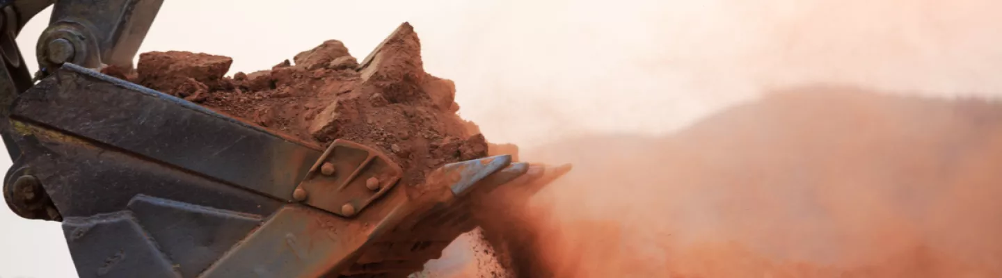 excavator bucket scooping dirt