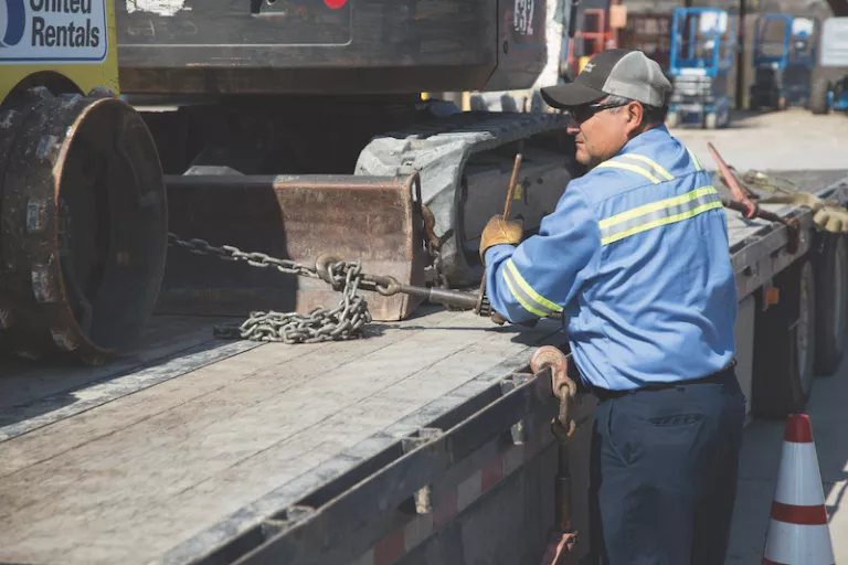 Man Loading Equipment on Trailer