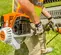 Orange, black, white and silver STIHL Brush Cutter, Gas Powered