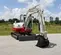 White, red and gray TAKEUCHI 10,000-12,000 lb. Mini Excavator