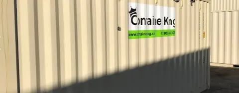beige shipping container under blue sky