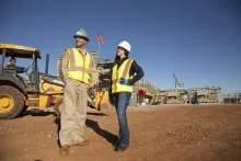 man and woman on construction site in PPE 
