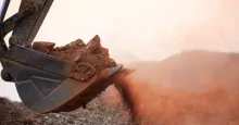 excavator bucket scooping dirt