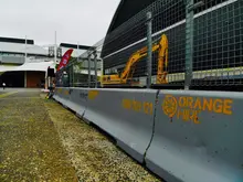 Concrete safety barriers lined up on a construction site, supplied by Orange Hire for traffic and site protection.