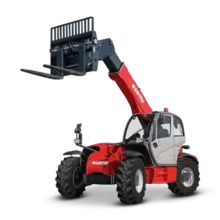 Telehandler truck with extended boom lifting materials on a construction site with safety barriers nearby.