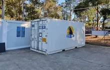  Two container storage units positioned in an open lot, representing modular storage solutions for industrial or commercial use.